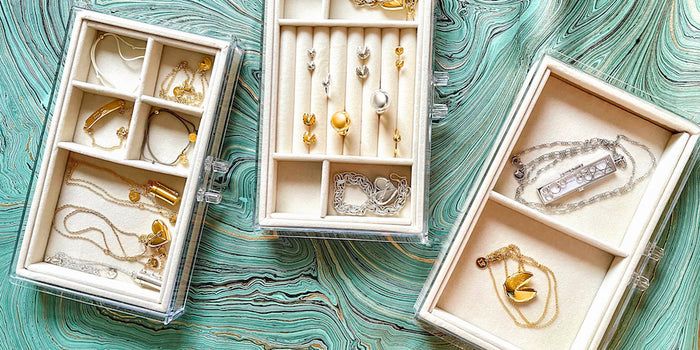 Shown Here: Three jewelry box inserts filled with various Fortune & Frame lockets, necklaces, bracelets and rings to demonstrate jewelry organization
